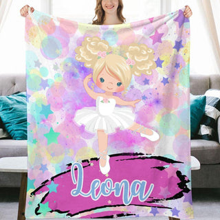 a girl holding a personalized blanket with a picture of a ballerina