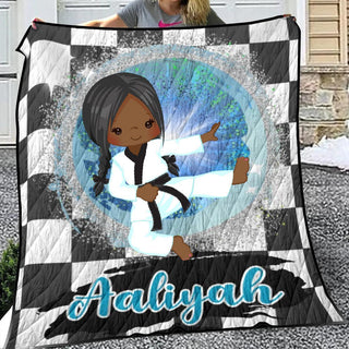 a woman holding a quilt with a picture of a girl on it