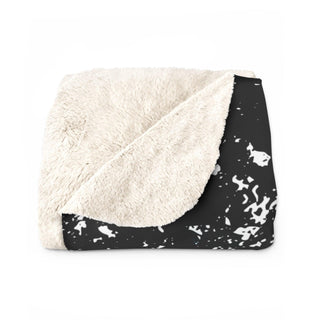 a black and white blanket on a white background