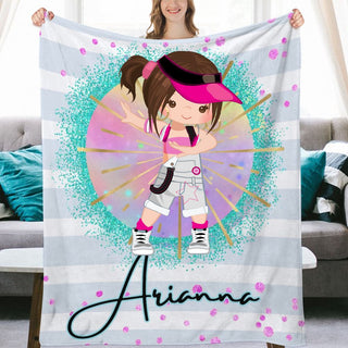 a girl holding up a personalized blanket