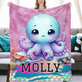 a woman holding a blanket with an octopus on it