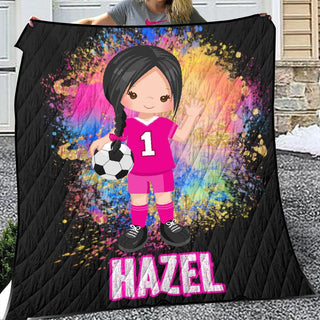 a girl holding a soccer ball and a blanket