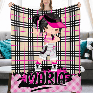 a woman holding up a pink and black blanket