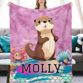 a woman holding a personalized blanket with an otter on it