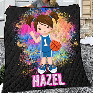 a woman holding a blanket with a picture of a girl holding a basketball