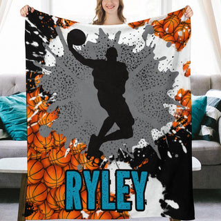 a woman holding up a blanket with a basketball player on it