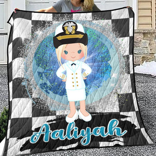 a woman holding a quilt with a picture of a sailor on it