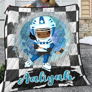 a girl holding a quilt with a picture of a football player on it