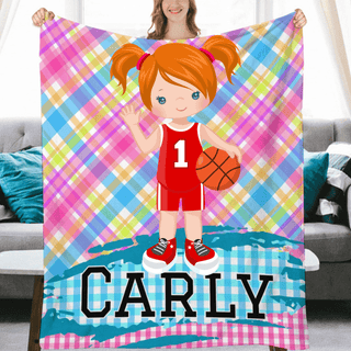 a girl holding a personalized blanket with a basketball on it