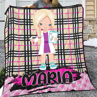 a woman holding a blanket with a picture of a girl on it