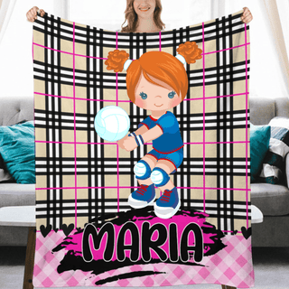 a woman holding a personalized blanket in front of a couch