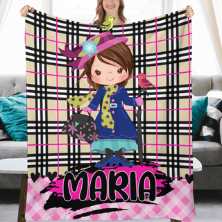 a girl holding up a personalized blanket