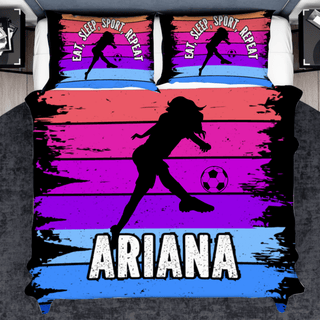 a bed with a picture of a girl kicking a soccer ball