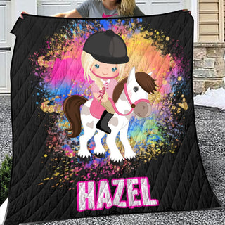 a girl holding a blanket with a horse on it