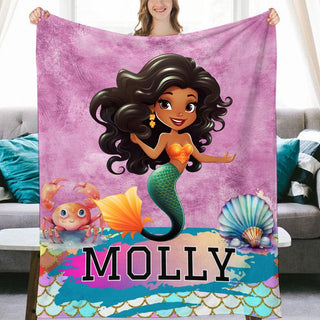 a woman holding a personalized blanket with a mermaid on it