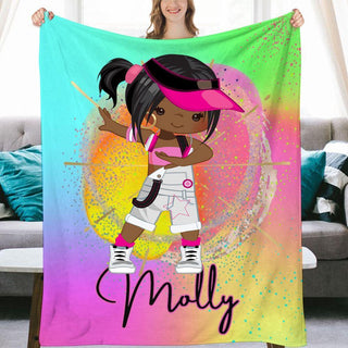 a girl holding up a colorful blanket with a name on it