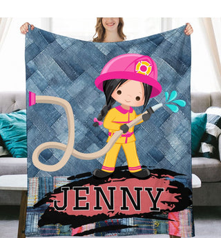 a girl in a fireman's uniform holding a personalized blanket