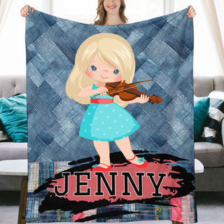 a girl holding a violin on top of a blanket