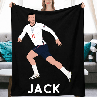 a woman holding a black towel with a picture of a soccer player